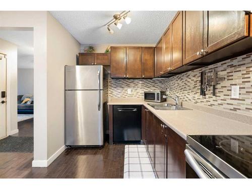 15-3200 60 Street Ne, Calgary, AB - Indoor Photo Showing Kitchen With Stainless Steel Kitchen With Double Sink