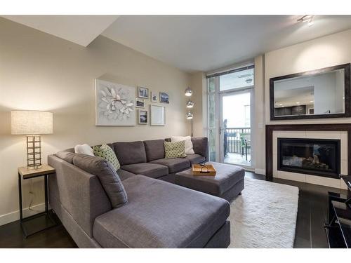 617-222 Riverfront Avenue Sw, Calgary, AB - Indoor Photo Showing Living Room With Fireplace