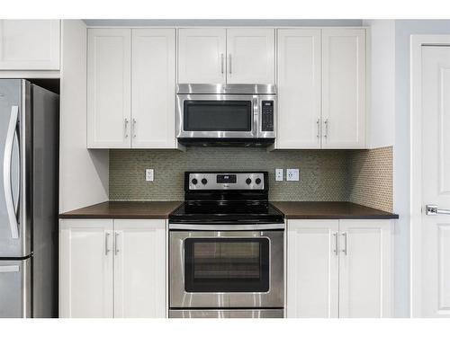 47 Sherwood Row Nw, Calgary, AB - Indoor Photo Showing Kitchen With Stainless Steel Kitchen