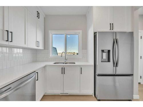 34 Lewiston Way, Calgary, AB - Indoor Photo Showing Kitchen With Double Sink