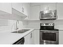 1103-302 Skyview Ranch Drive Ne, Calgary, AB  - Indoor Photo Showing Kitchen With Stainless Steel Kitchen With Double Sink With Upgraded Kitchen 