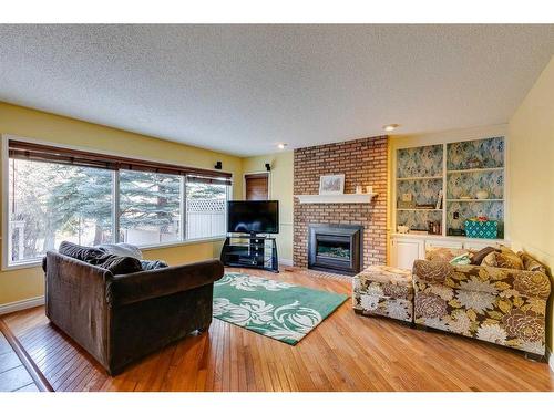 912 Shawnee Drive Sw, Calgary, AB - Indoor Photo Showing Living Room With Fireplace