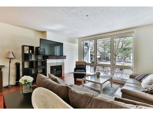 104-41 6A Street Ne, Calgary, AB - Indoor Photo Showing Living Room With Fireplace