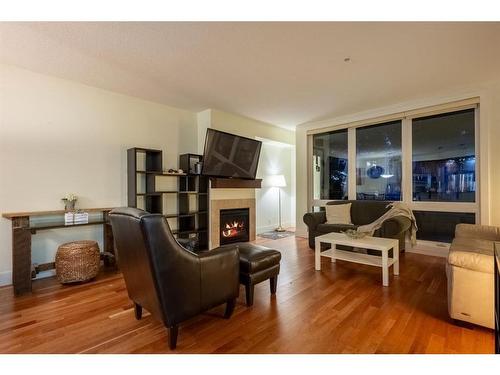 104-41 6A Street Ne, Calgary, AB - Indoor Photo Showing Living Room With Fireplace