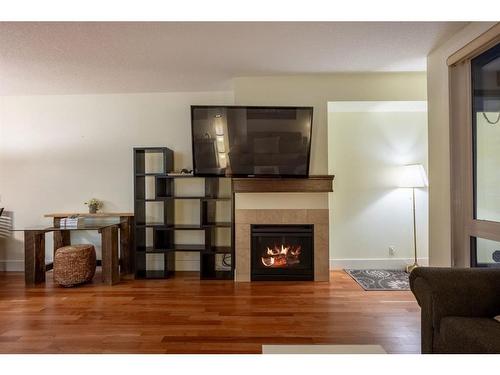 104-41 6A Street Ne, Calgary, AB - Indoor Photo Showing Living Room With Fireplace