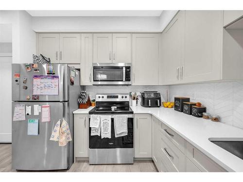 305-150 Shawnee Square Sw, Calgary, AB - Indoor Photo Showing Kitchen