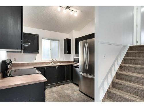 80 Rivercrest Crescent Se, Calgary, AB - Indoor Photo Showing Kitchen With Double Sink