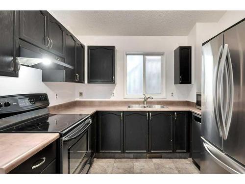 80 Rivercrest Crescent Se, Calgary, AB - Indoor Photo Showing Kitchen With Stainless Steel Kitchen With Double Sink