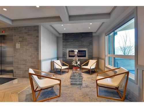 108-145 Burma Star Road Sw, Calgary, AB - Indoor With Fireplace