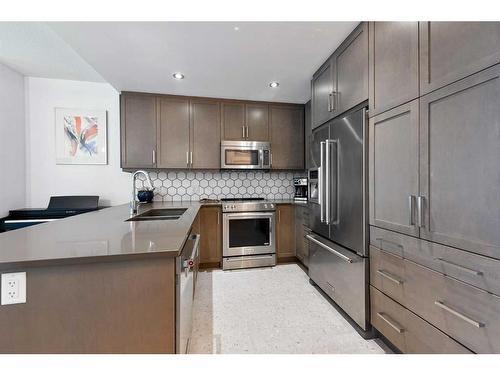 108-145 Burma Star Road Sw, Calgary, AB - Indoor Photo Showing Kitchen With Double Sink With Upgraded Kitchen