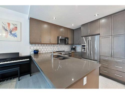 108-145 Burma Star Road Sw, Calgary, AB - Indoor Photo Showing Kitchen With Double Sink With Upgraded Kitchen