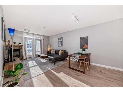 301-4 Hemlock Crescent Sw, Calgary, AB - Indoor Photo Showing Other Room With Fireplace