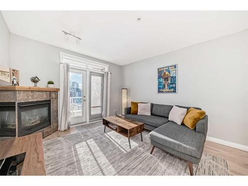 301-4 Hemlock Crescent Sw, Calgary, AB - Indoor Photo Showing Living Room With Fireplace