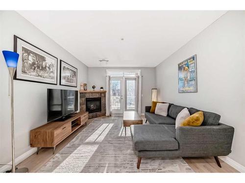 301-4 Hemlock Crescent Sw, Calgary, AB - Indoor Photo Showing Living Room With Fireplace