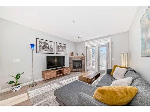 301-4 Hemlock Crescent Sw, Calgary, AB - Indoor Photo Showing Living Room With Fireplace