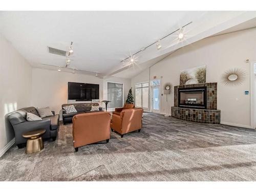 301-4 Hemlock Crescent Sw, Calgary, AB - Indoor Photo Showing Living Room With Fireplace