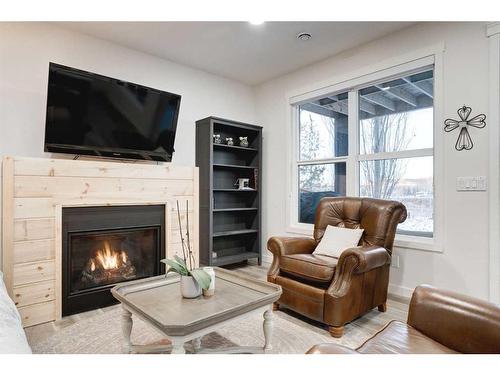 50 Riviera View, Cochrane, AB - Indoor Photo Showing Living Room With Fireplace