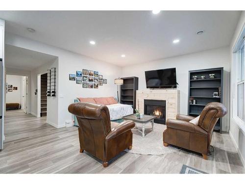 50 Riviera View, Cochrane, AB - Indoor Photo Showing Living Room With Fireplace