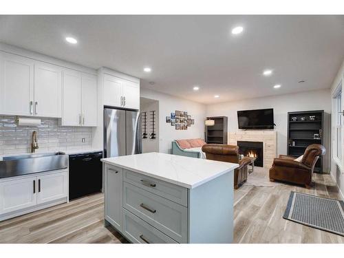 50 Riviera View, Cochrane, AB - Indoor Photo Showing Kitchen With Fireplace With Stainless Steel Kitchen With Upgraded Kitchen