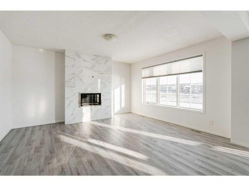 76 Carrington Close Nw, Calgary, AB - Indoor Photo Showing Living Room With Fireplace