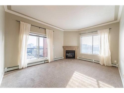 406-881 15 Avenue Sw, Calgary, AB - Indoor Photo Showing Living Room With Fireplace