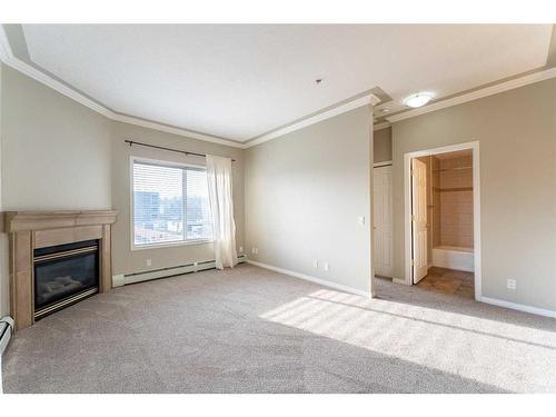 406-881 15 Avenue Sw, Calgary, AB - Indoor Photo Showing Living Room With Fireplace