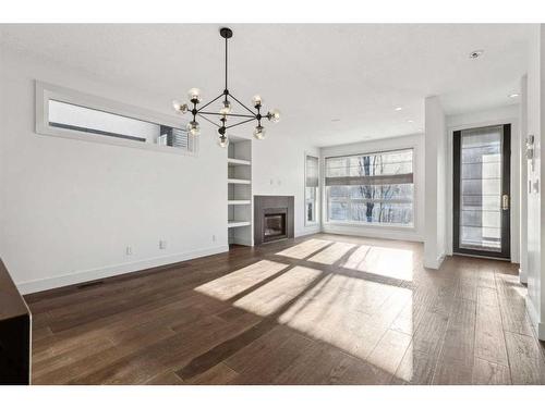 1-836 Mcpherson Road Ne, Calgary, AB - Indoor Photo Showing Other Room With Fireplace