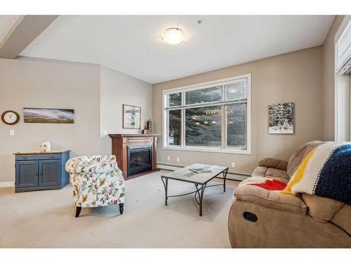 104-35 Aspenmont Heights Sw, Calgary, AB - Indoor Photo Showing Living Room With Fireplace