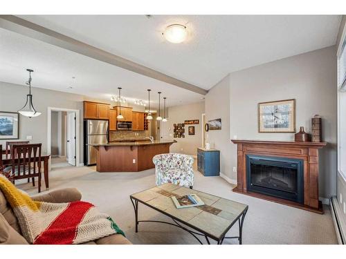 104-35 Aspenmont Heights Sw, Calgary, AB - Indoor Photo Showing Living Room With Fireplace