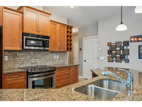 104-35 Aspenmont Heights Sw, Calgary, AB - Indoor Photo Showing Kitchen With Stainless Steel Kitchen With Double Sink With Upgraded Kitchen