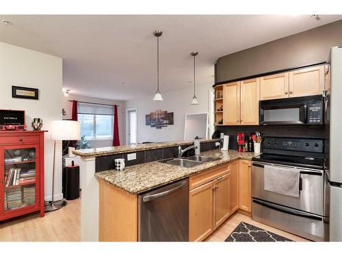 105-303 19 Avenue Sw, Calgary, AB - Indoor Photo Showing Kitchen With Double Sink