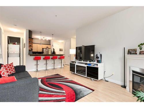 105-303 19 Avenue Sw, Calgary, AB - Indoor Photo Showing Living Room With Fireplace