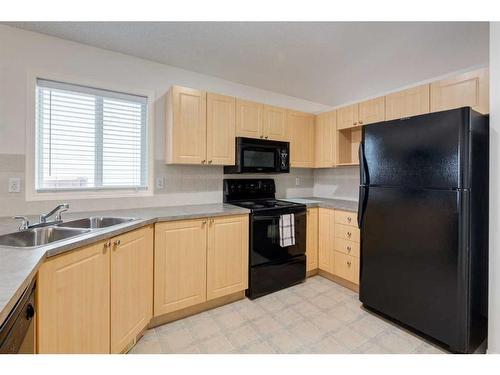 2038 Bridlemeadows Manor Sw, Calgary, AB - Indoor Photo Showing Kitchen With Double Sink