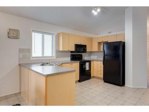 2038 Bridlemeadows Manor Sw, Calgary, AB - Indoor Photo Showing Kitchen With Double Sink