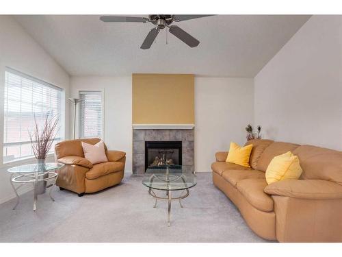 2038 Bridlemeadows Manor Sw, Calgary, AB - Indoor Photo Showing Living Room With Fireplace