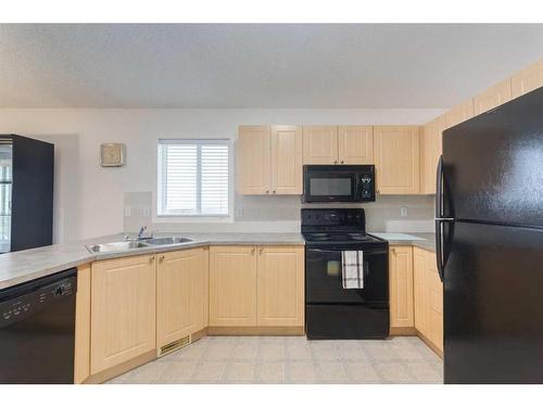 2038 Bridlemeadows Manor Sw, Calgary, AB - Indoor Photo Showing Kitchen With Double Sink