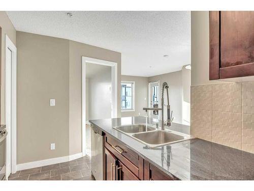 405-2715 12 Avenue Se, Calgary, AB - Indoor Photo Showing Kitchen With Double Sink