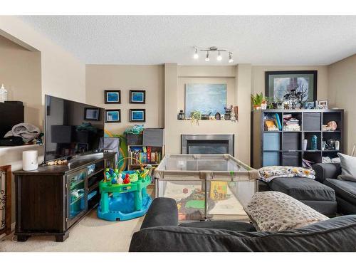 308 Evermeadow Road Sw, Calgary, AB - Indoor Photo Showing Living Room With Fireplace