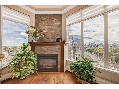 904-1726 14 Avenue Nw, Calgary, AB - Indoor Photo Showing Living Room With Fireplace