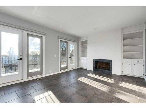 10-448 Strathcona Drive Sw, Calgary, AB - Indoor Photo Showing Living Room With Fireplace