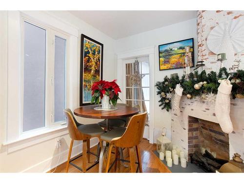 223 2 Avenue Ne, Calgary, AB - Indoor Photo Showing Dining Room With Fireplace