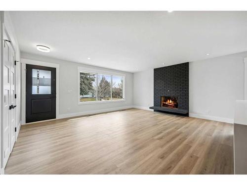 36 Maple Court Crescent Se, Calgary, AB - Indoor Photo Showing Living Room With Fireplace