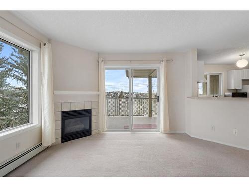 2301-20 Harvest Rose Park Ne, Calgary, AB - Indoor Photo Showing Living Room With Fireplace