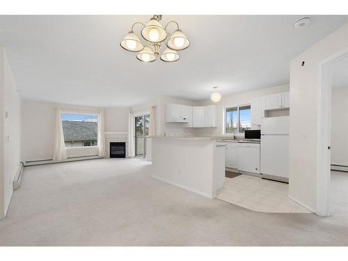 2301-20 Harvest Rose Park Ne, Calgary, AB - Indoor Photo Showing Kitchen With Fireplace