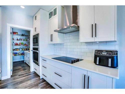 937 Midtown Avenue Sw, Airdrie, AB - Indoor Photo Showing Kitchen With Upgraded Kitchen