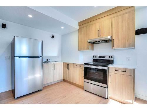 937 Midtown Avenue Sw, Airdrie, AB - Indoor Photo Showing Kitchen With Stainless Steel Kitchen