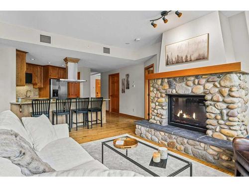 101-505 Spring Creek Drive, Canmore, AB - Indoor Photo Showing Living Room With Fireplace