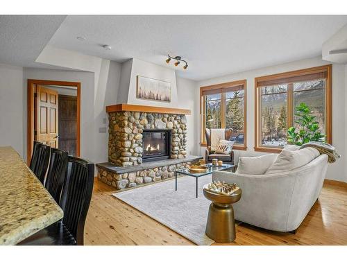 101-505 Spring Creek Drive, Canmore, AB - Indoor Photo Showing Living Room With Fireplace