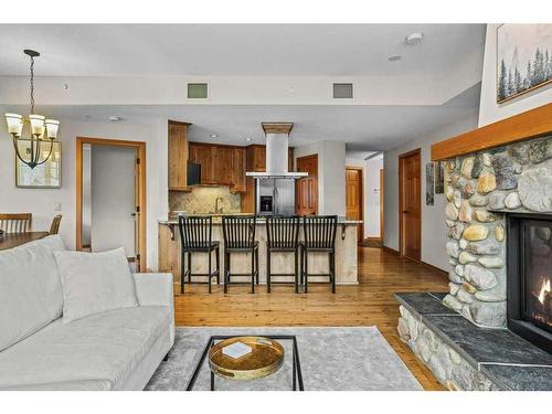 101-505 Spring Creek Drive, Canmore, AB - Indoor Photo Showing Living Room With Fireplace