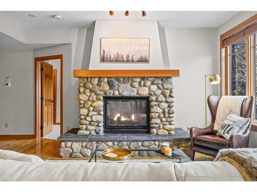 101-505 Spring Creek Drive, Canmore, AB - Indoor Photo Showing Living Room With Fireplace